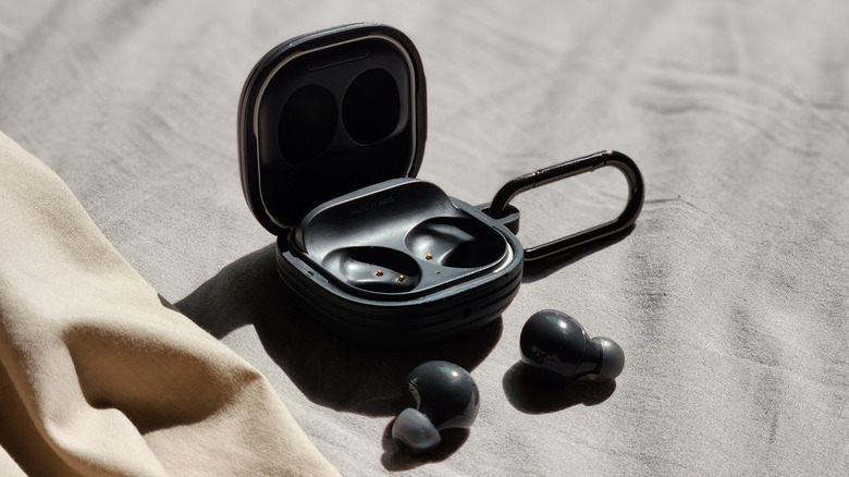 Top view of an open Galaxy Buds case with earbuds on a flat surface.