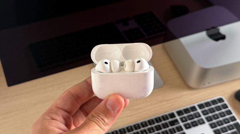 A close-up of the AirPods Pro 3 charging case sitting on a wooden surface.