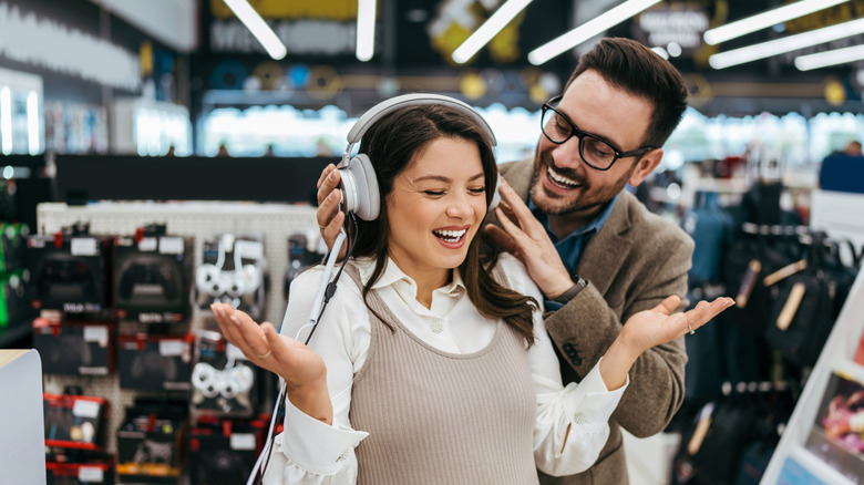 A couple looking at electronic products together in a store.