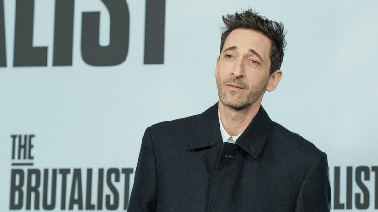 Actor Adrien Brody attending a movie premiere on the red carpet.