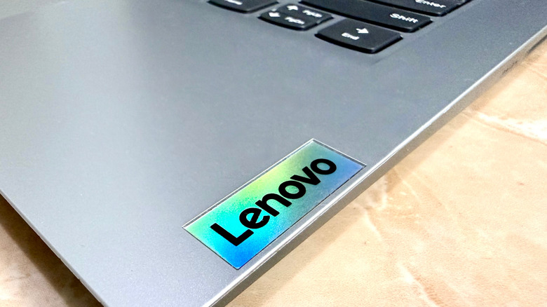 Macro shot of the Lenovo logo on a durable business-grade laptop.