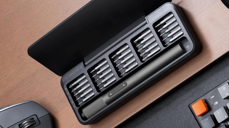 HOTO mini electric screwdriver set with multiple bits in its portable charging case.