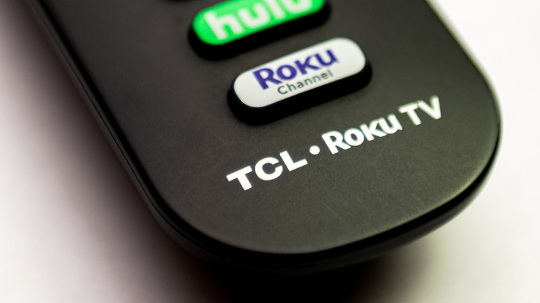 Close-up of a standard Roku TV remote showing the navigation and special function buttons.