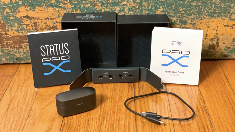 The Status Pro X packaging including the case, cable, and various sizes of ear tips.
