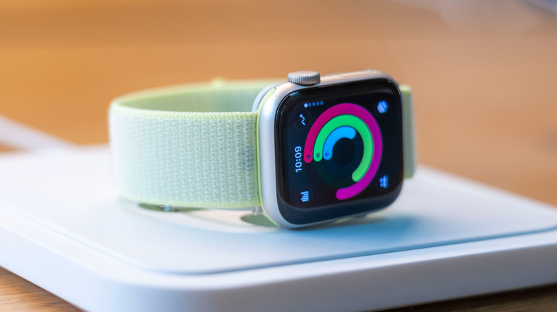 Apple Watch Series 11 resting on its magnetic charger.