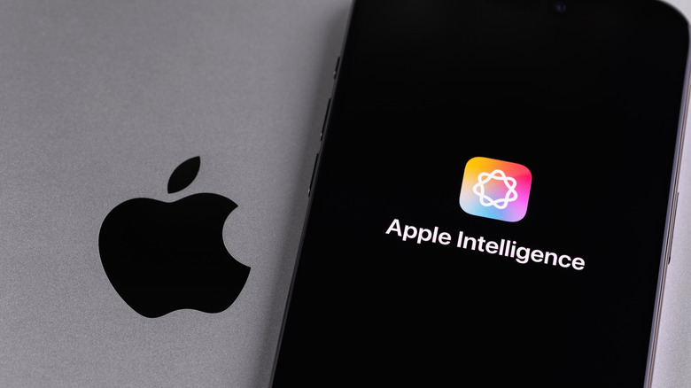 Close-up of an iPhone screen showing the Apple Intelligence icon sitting on a MacBook.