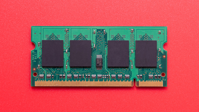 A single stick of desktop computer RAM against a vibrant red background.