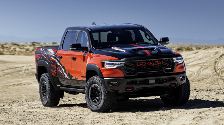 2027 Ram 1500 SRT TRX kicking up sand in a desert environment.