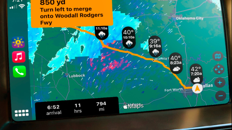 A CarPlay dashboard display showing the Weather on the Way app with a localized weather radar overlay on a map.