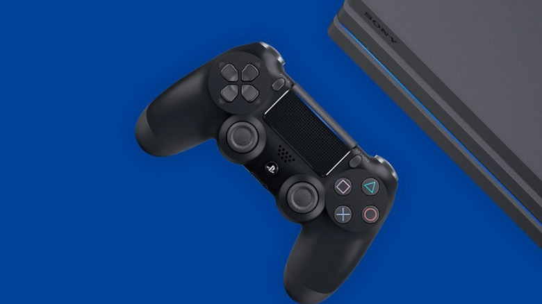 The sleek, compact profile of a PlayStation 4 Slim console sitting next to a controller.