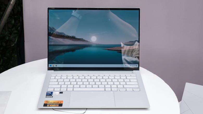 The ASUS Zenbook S 14 with its unique finish sitting on a round table.