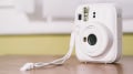 A Fujifilm Instax Mini 13 instant camera in a pastel blue color.