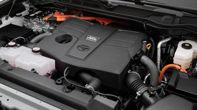 Detailed view of the Toyota i-Force MAX hybrid engine bay under the hood.