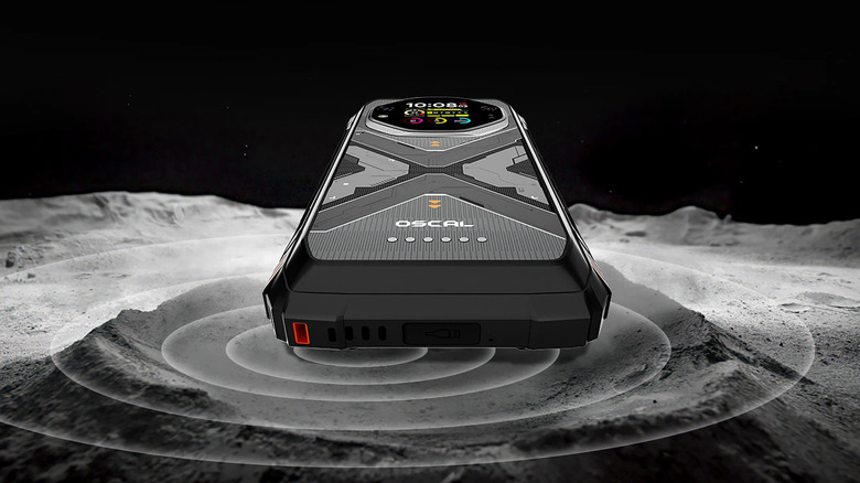 Detailed close-up of the bottom edge and port cover of the Oscal Tank 1 on a gray surface.