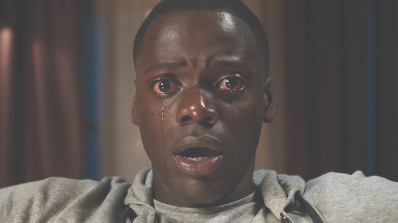A close-up of Chris Washington crying during the hypnotic 'sunken place' scene.