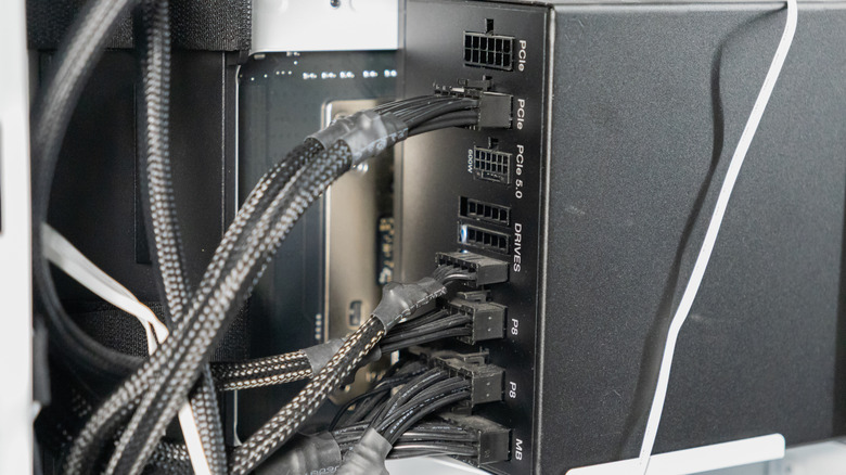 Close-up of black modular power supply cables and their plastic connectors.