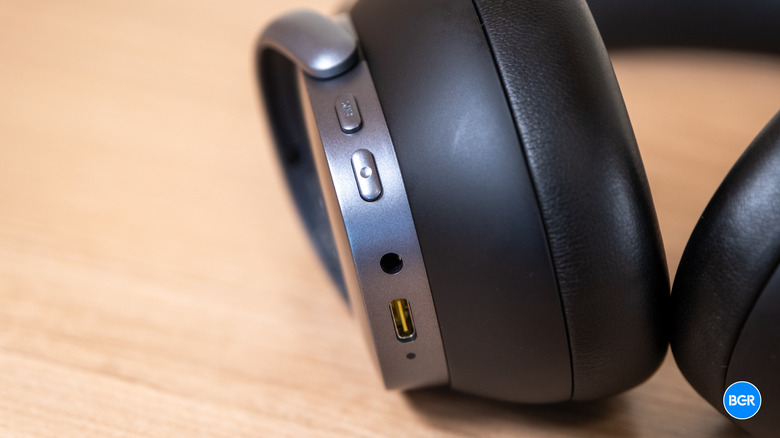 Detail shot of the physical control buttons located on the underside of the ear cup.