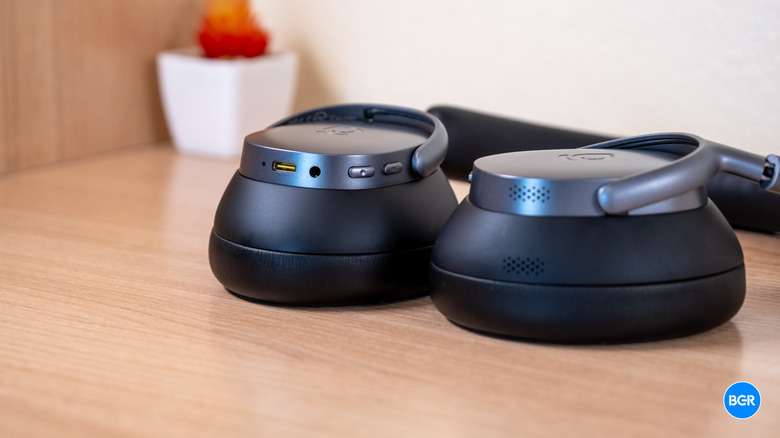 Baseus XH1 headphones resting flat on a surface, highlighting their sleek profile.