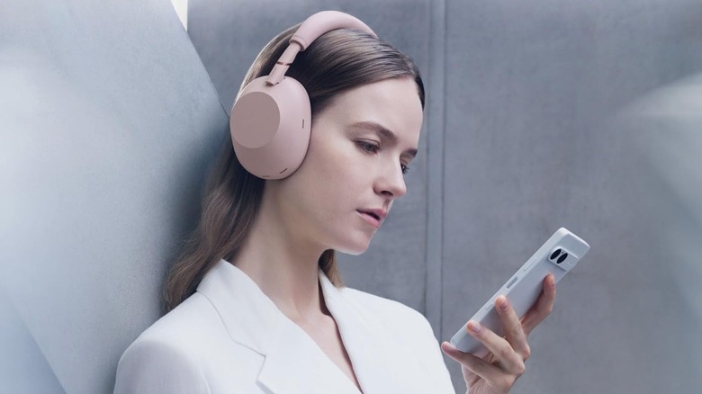 Side profile of a woman wearing the Sony WH-1000XM6 headphones.