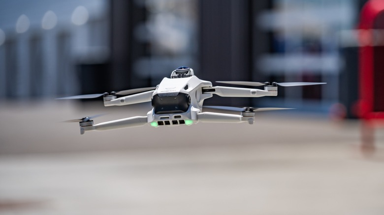The Antigravity A1 drone captured in motion while flying over a go-kart racing track.