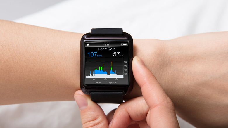 A smartwatch interface showing real-time heart rate and health tracking statistics.